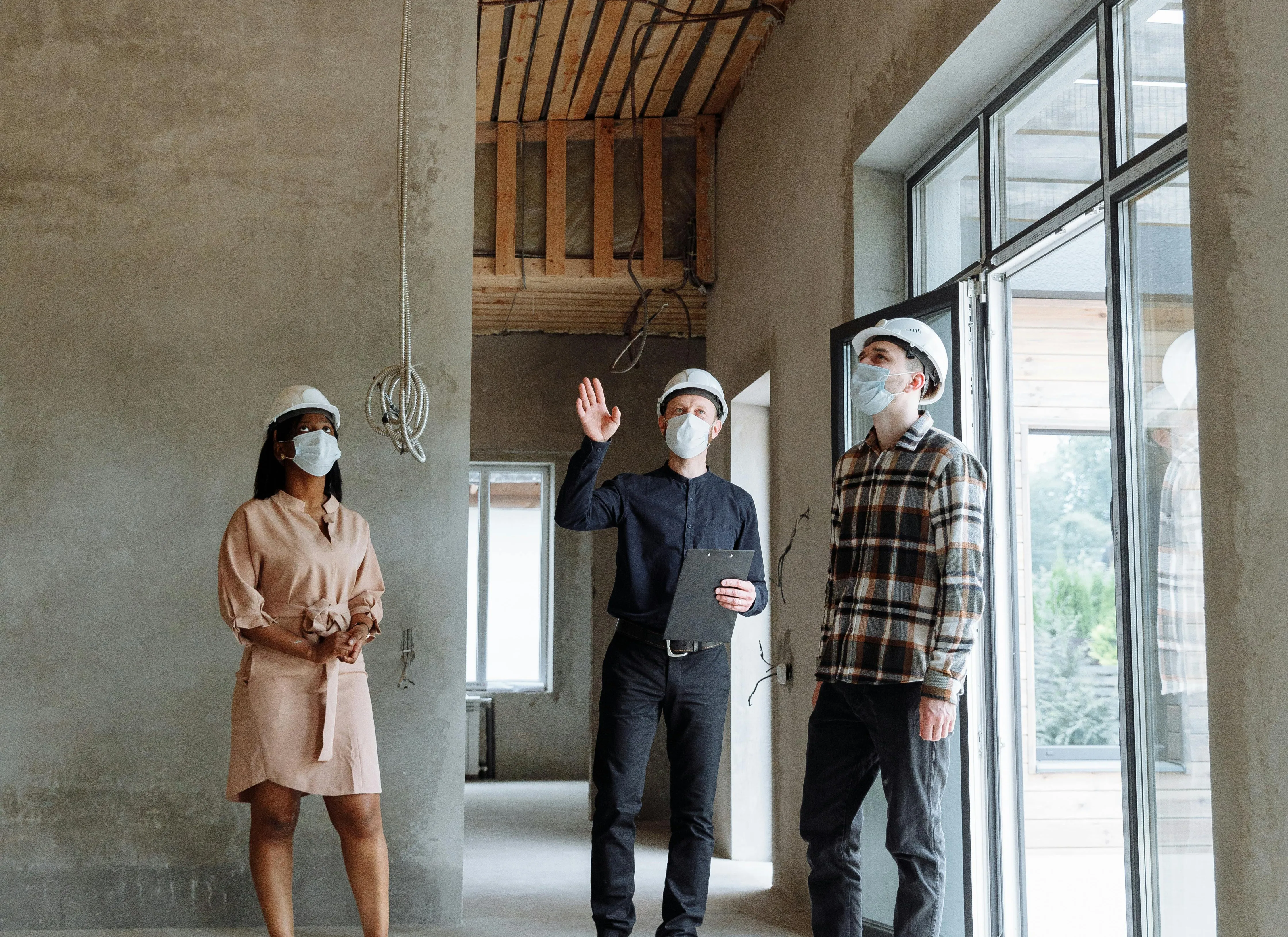 An interior with a luxury toilet and sink with clear glass panes, trees visible on the sides.